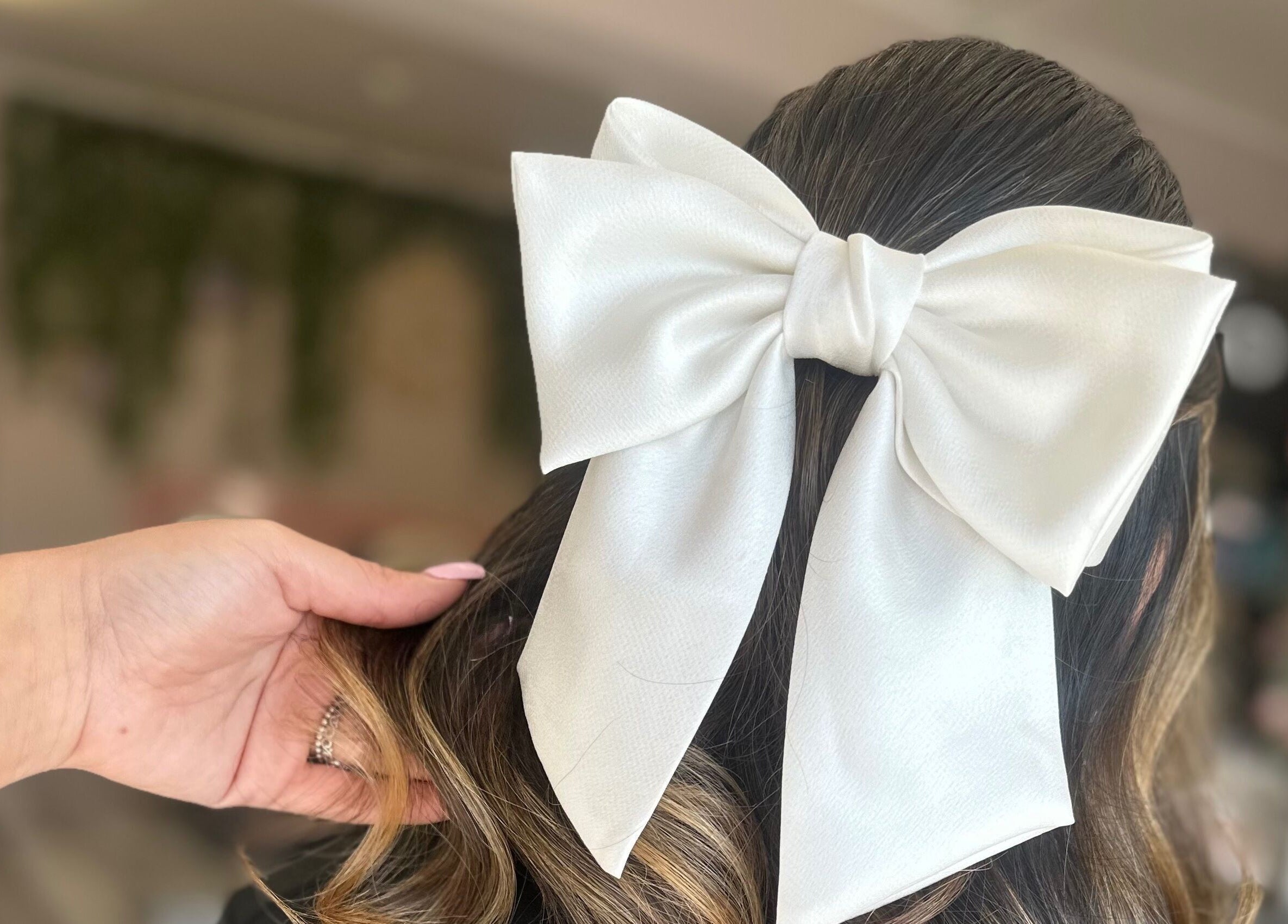 Stylish white bow adorning hair at Everleigh Hair Design, Dublin, County Dublin, IE.