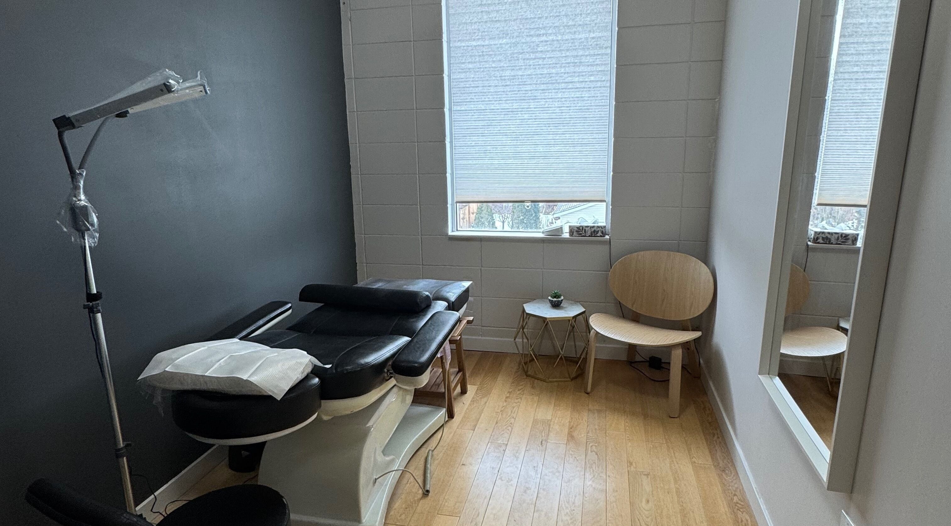 Massage room at JPMU by Palette, Edmonton, Alberta, CA with black massage table and modern decor.
