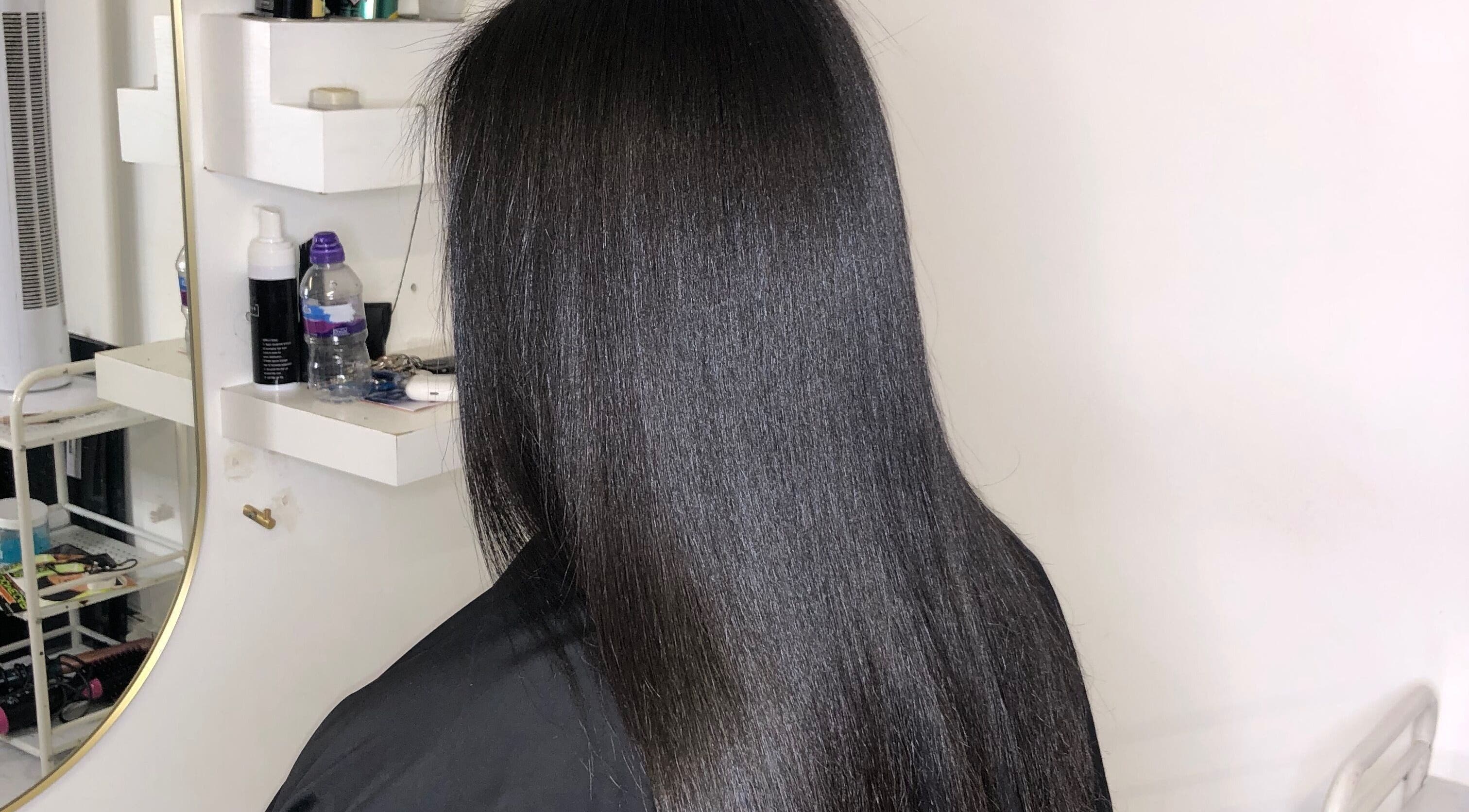 Sleek black hair styled at Swish London in London, England, GB showcasing smooth and shiny finish.