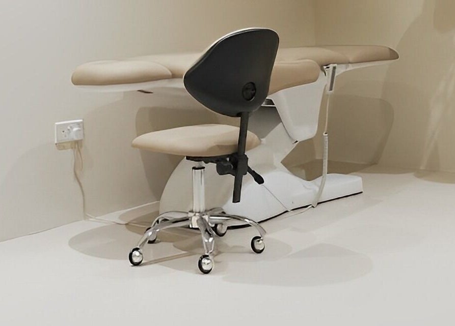 Modern treatment chair and stool at nnstudio, Singapore, Singapore, SG, offering a calming ambiance.