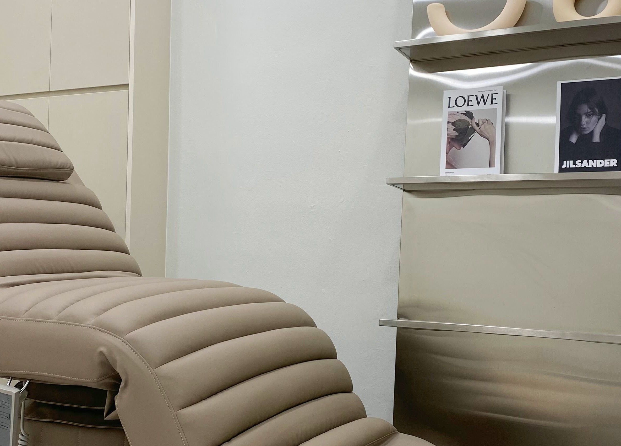 Comfortable spa chair at nnstudio, Singapore, Singapore, SG, next to stylish magazines.