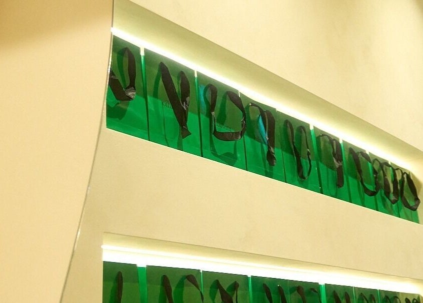 Stylish green bags illuminated on a wall at nnstudio, Singapore, Singapore, SG.