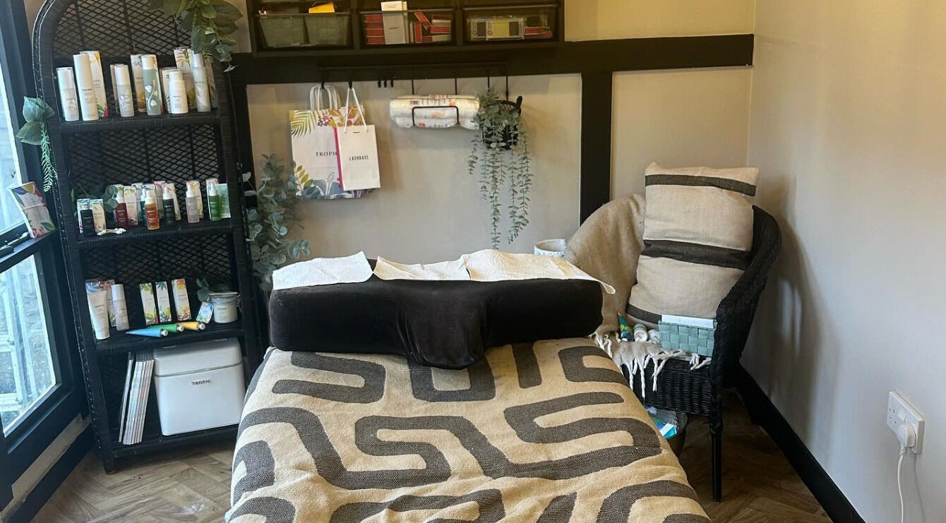 Relaxing treatment room at Dollface Beauty by Beth, Lostock Hall, England, GB, featuring a cozy massage bed.