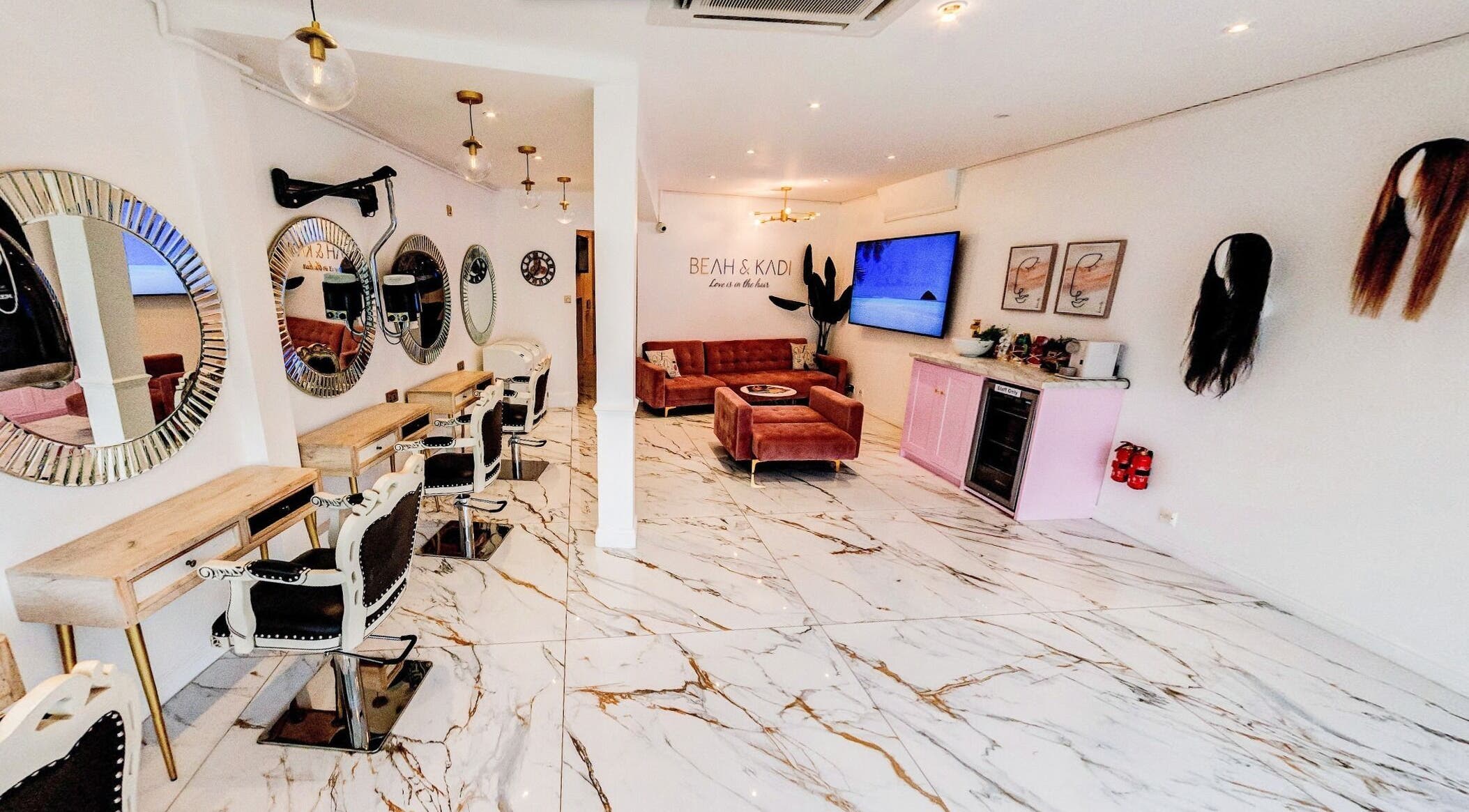 Chic interior of Beah and Kadi Hair Lounge in London, England, GB with mirrors and styling stations.