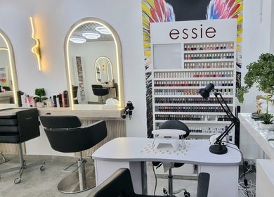 Stylish interior of Mike and Kals beauty salon in Dubai, AE with modern mirrors and nail polish display.