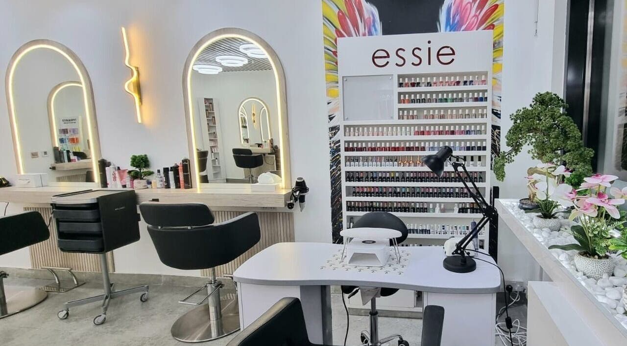 Stylish interior of Mike and Kals beauty salon in Dubai, AE with modern mirrors and nail polish display.