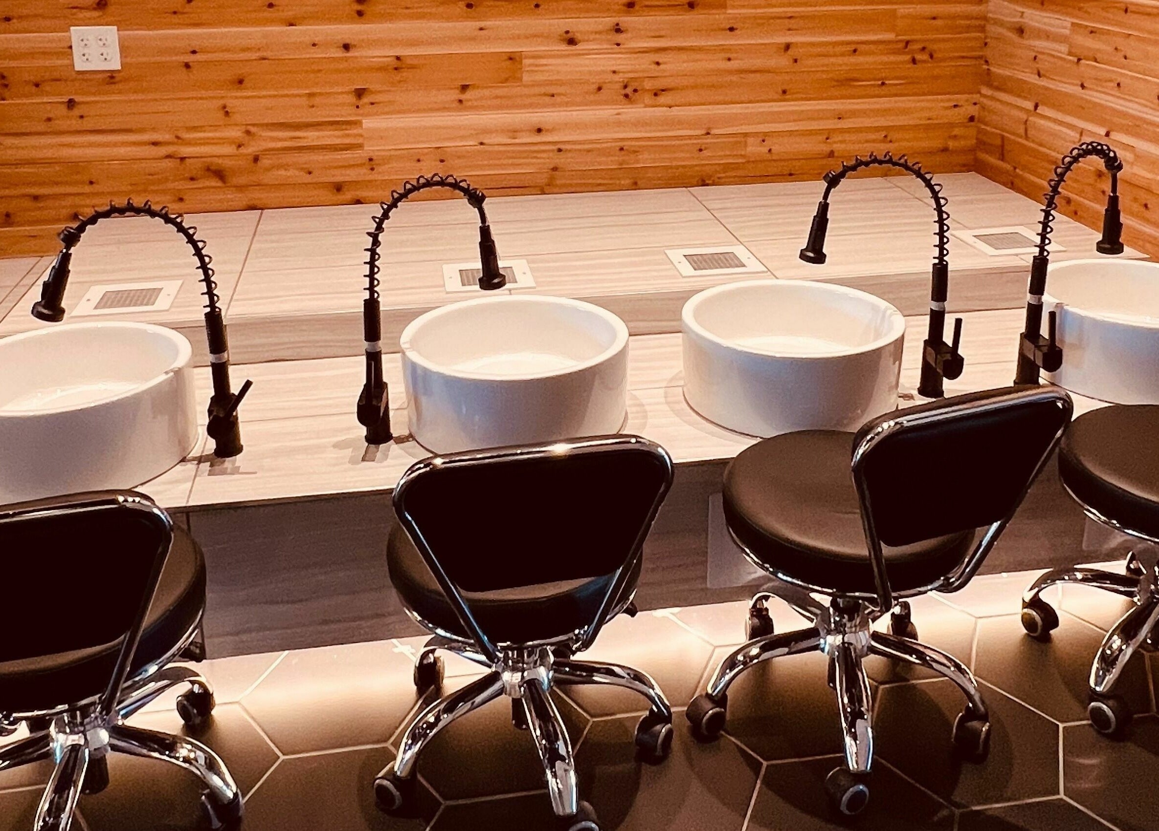 Modern pedicure stations at Bennington Nail Bar, Bennington, Nebraska, US, with stylish black chairs.