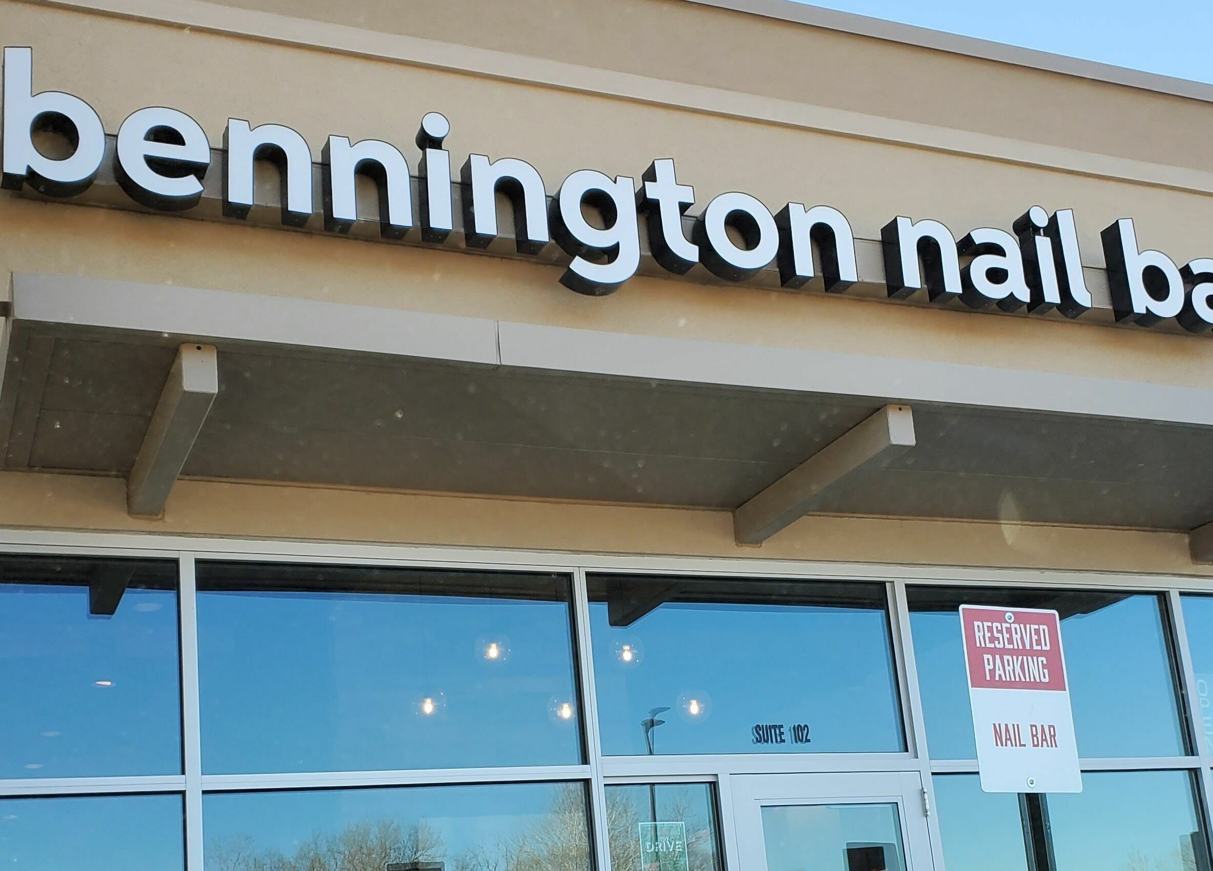 Front entrance of Bennington Nail Bar in Bennington, Nebraska, US with clear signage.