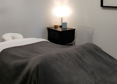 A serene massage room at Clinical Elements, Loveland, Ohio, US, featuring a massage table and soft lighting.
