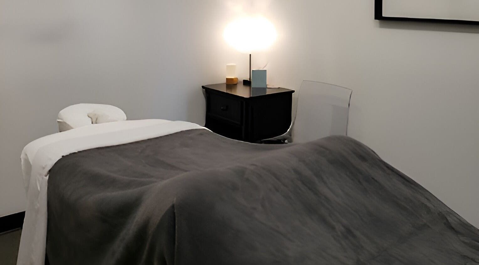 A serene massage room at Clinical Elements, Loveland, Ohio, US, featuring a massage table and soft lighting.