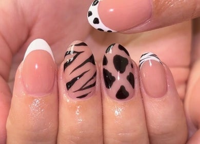 Stylish nail art at The Nail Garden in Lansing, Michigan, US featuring animal print designs.