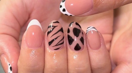 Stylish nail art at The Nail Garden in Lansing, Michigan, US featuring animal print designs.