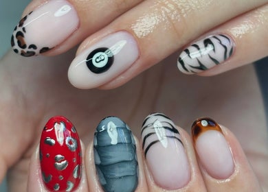 Creative nail designs at The Nail Garden, Lansing, Michigan, US, showcasing diverse art styles.