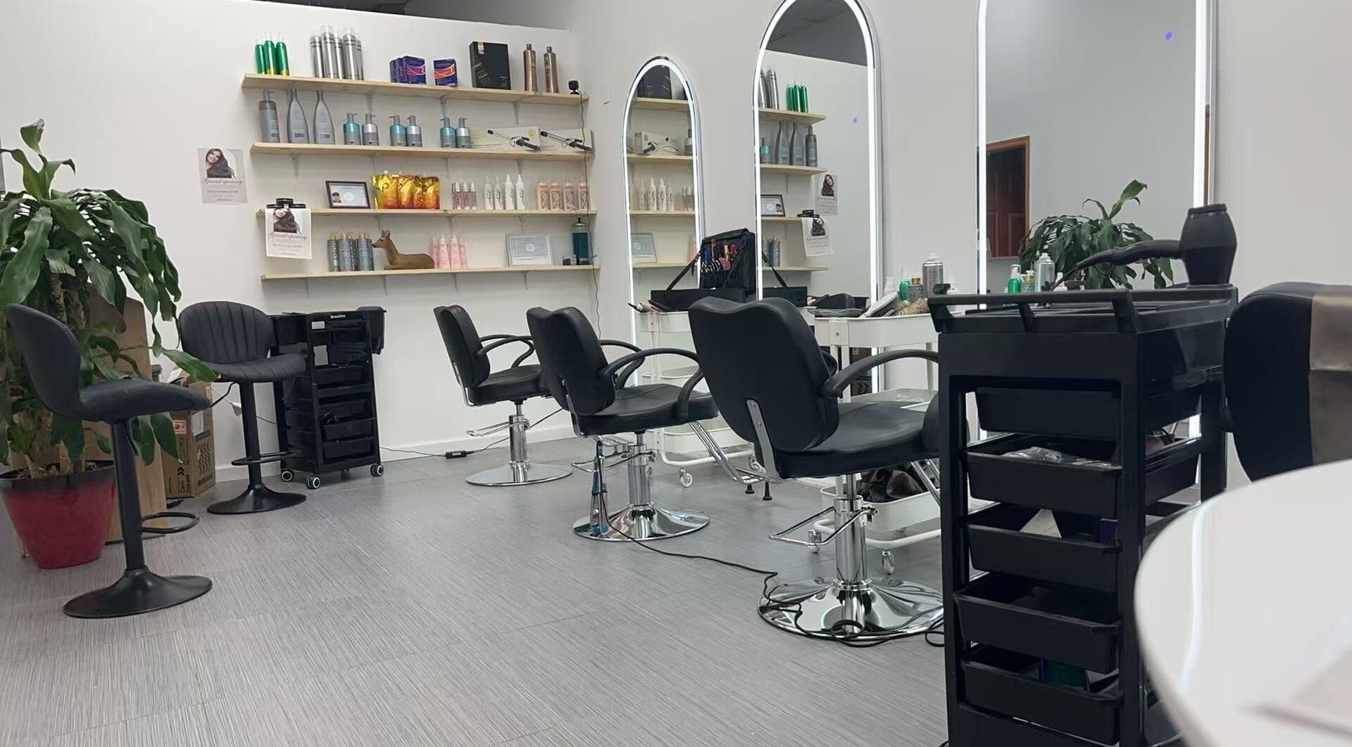 Modern interior of Garden Hair Beauty Salon in Carle Place, New York, US showcasing sleek salon chairs and mirrors.
