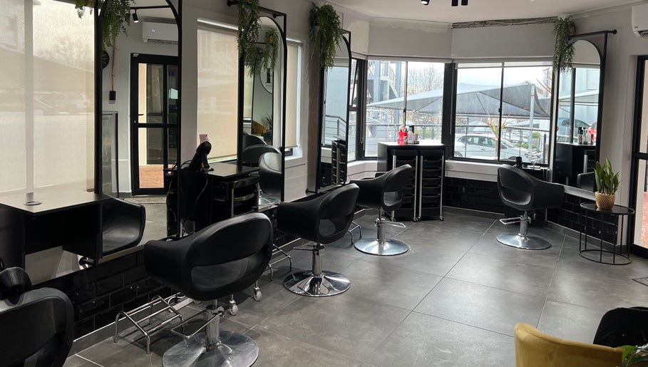 Interior of Anthea Hairstylist salon in Stellenbosch, featuring sleek chairs and modern decor.