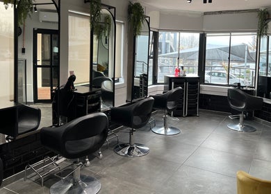 Interior of Anthea Hairstylist salon in Stellenbosch, featuring sleek chairs and modern decor.