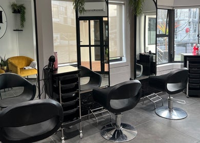 Modern salon interior at Anthea Hairstylist, Stellenbosch, Western Cape, ZA with stylish black seating.