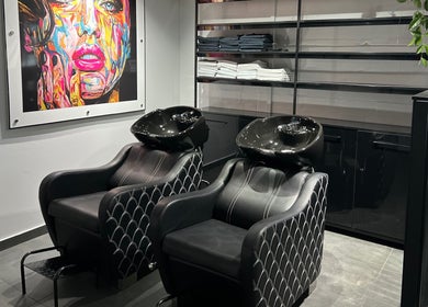 Modern salon wash stations at Anthea Hairstylist, Stellenbosch, Western Cape, ZA with vibrant artwork.
