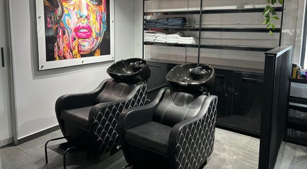 Modern salon wash stations at Anthea Hairstylist, Stellenbosch, Western Cape, ZA with vibrant artwork.