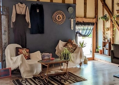 Cozy interior of HIVEhair by Tabbie in The Barn, Wrentham, England, GB with chairs and decor.