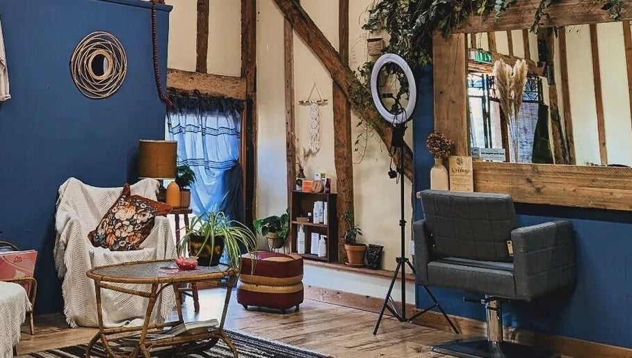 Rustic and cozy interior of HIVEhair by Tabbie in The Barn, Wrentham, England, GB, featuring wooden beams.