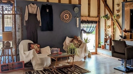 Cozy interior of HIVEhair by Tabbie in The Barn, Wrentham, England, GB. Featuring a rustic, inviting decor.