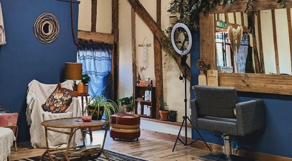 Cozy interior of HIVEhair by Tabbie in The Barn, Wrentham, England, GB showcasing a rustic salon seating area.