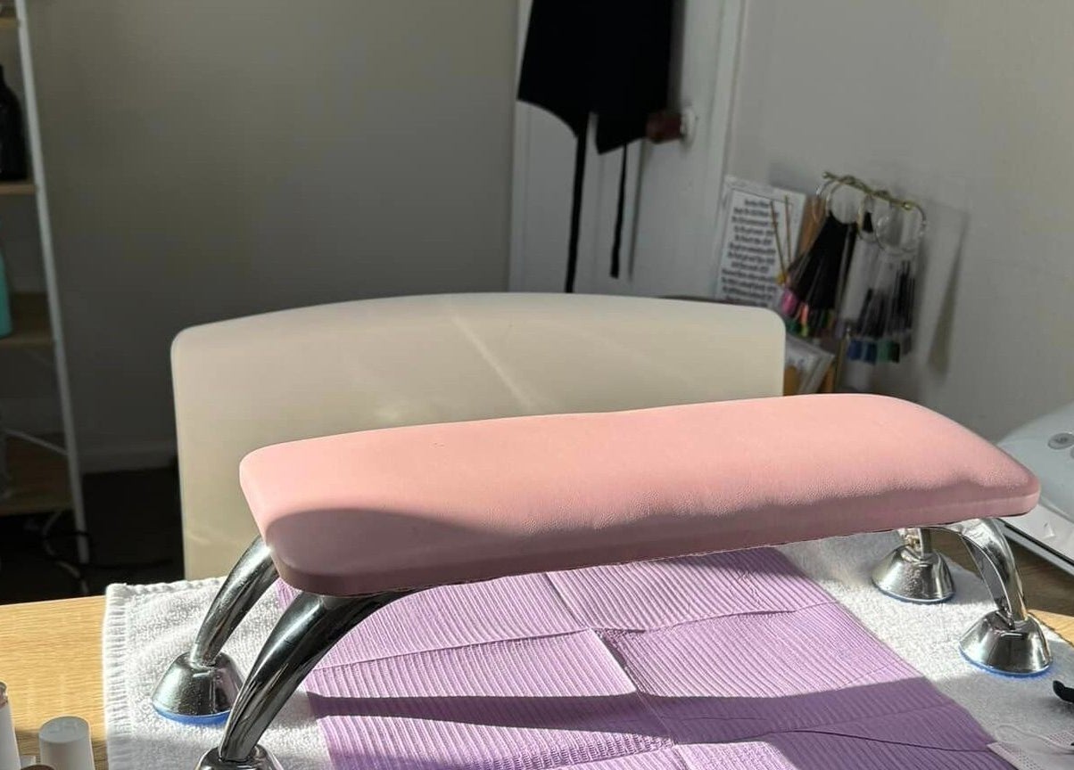 Nail station setup at Flo Nails and Lashes by KC, Invercargill, Southland, NZ. Includes pink pad and nail tools.