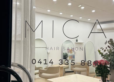 Chic interior view of Mica Hair salon in Melbourne, Victoria, AU with stylish decor and comfortable seating.