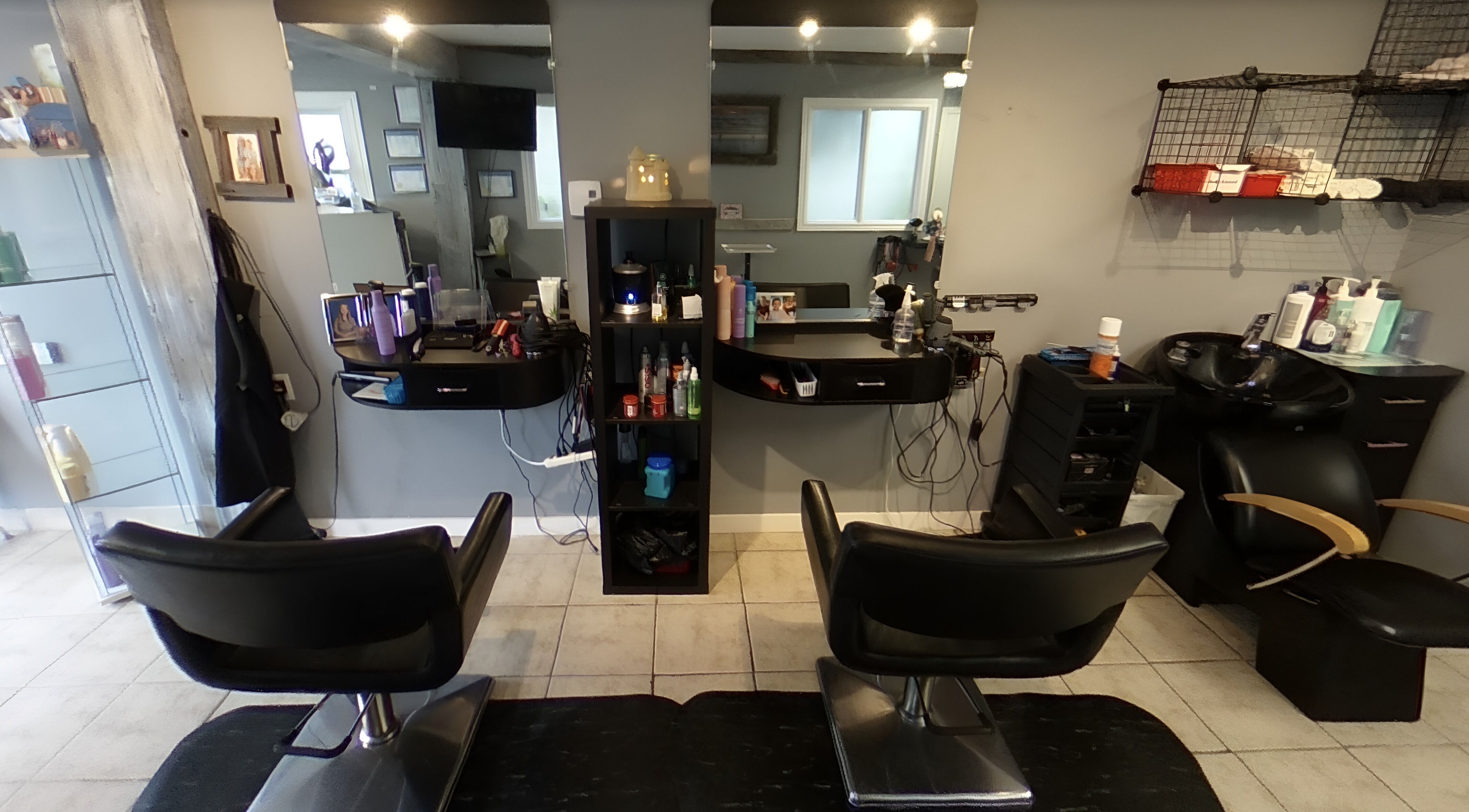 Modern interior of Beach Barbers Salon at Wasaga Beach, Ontario, CA. Stylish chairs and mirrors.
