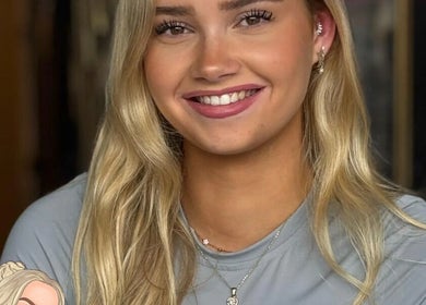 Smiling woman with ear piercings at Empress Piercing Cardiff, Cardiff, Wales, GB.