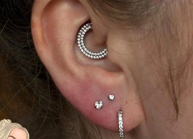 Elegant ear piercings featuring diamond studs at Empress Piercing Cardiff, Cardiff, Wales, GB.