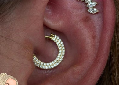 Elegant ear piercing with sparkling hoops at Empress Piercing Cardiff, Cardiff, Wales, GB.