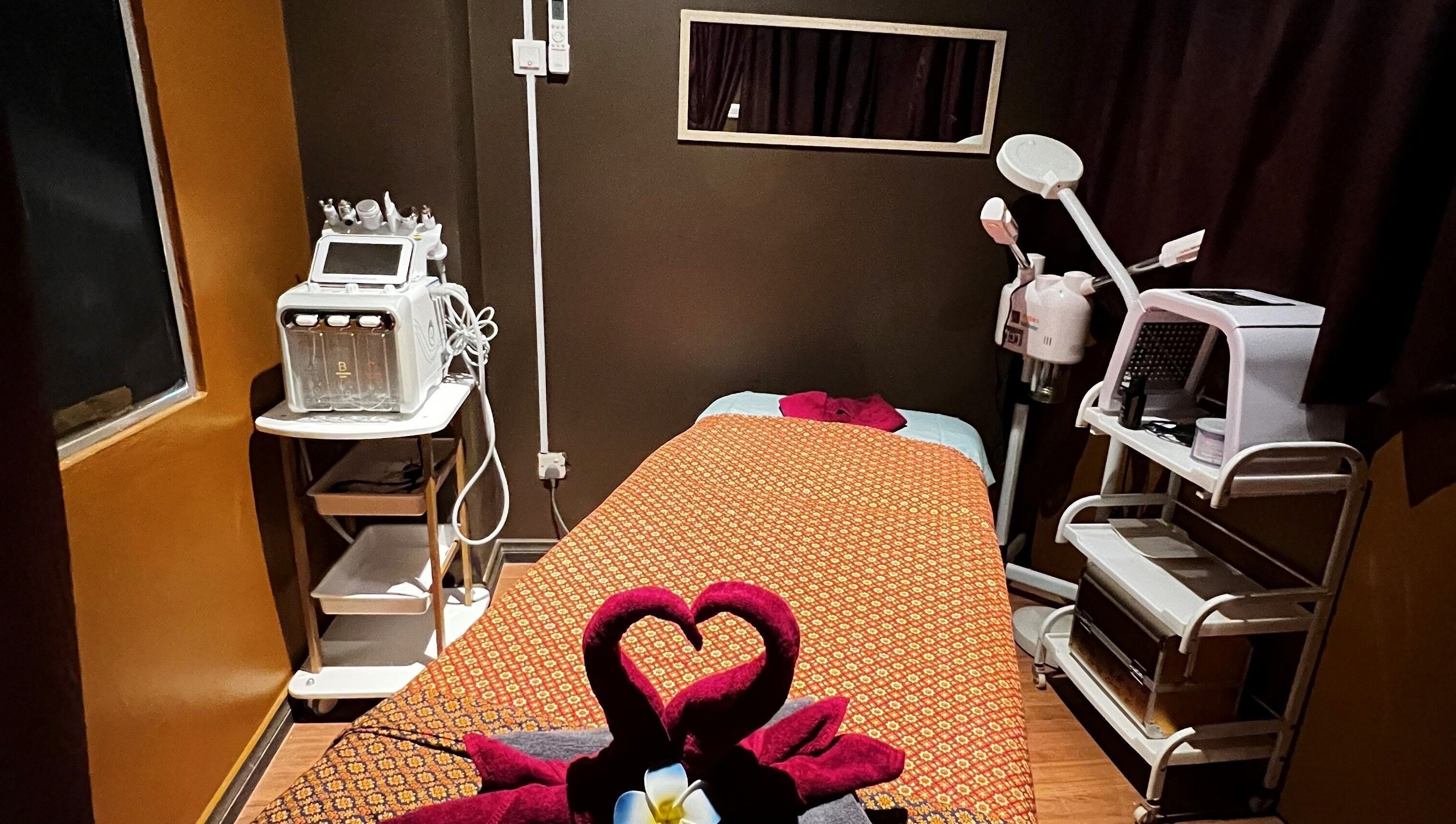 Cozy treatment room at Siam Wellness Centre and Beauty Spa, Kota Kinabalu, Sabah, MY with massage bed and equipment.