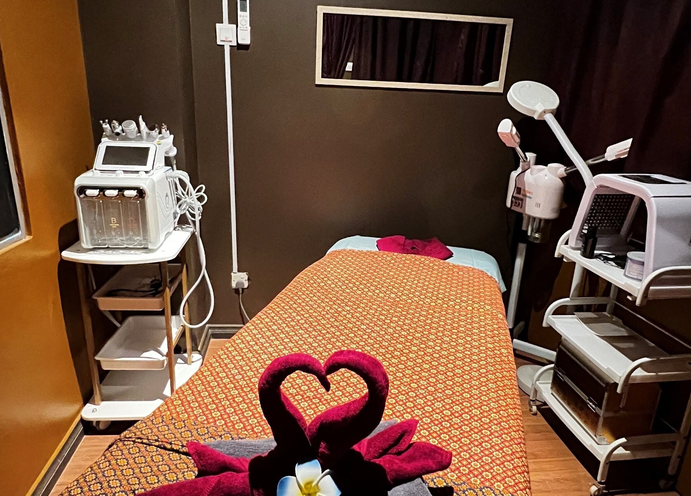 Cozy treatment room at Siam Wellness Centre and Beauty Spa, Kota Kinabalu, Sabah, MY with massage bed and equipment.