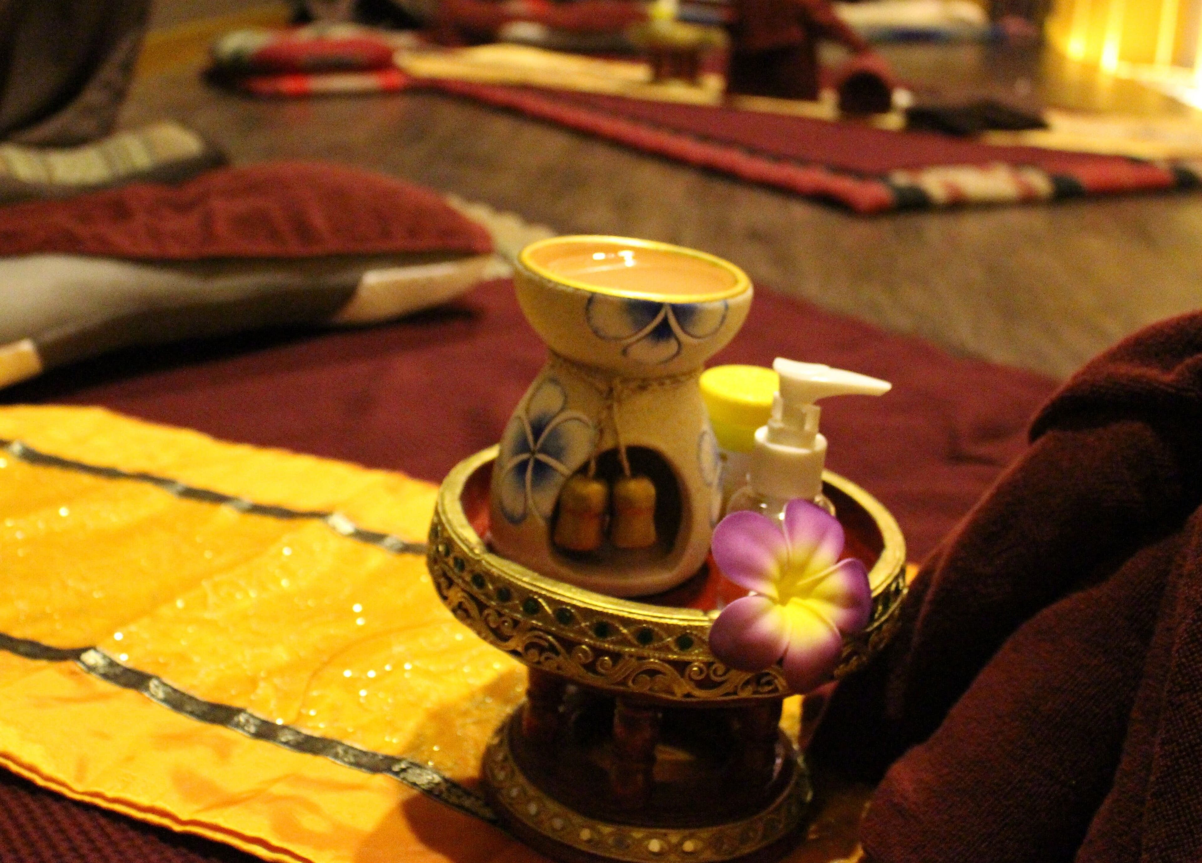 Relaxing spa setup at Siam Wellness Centre and Family Spa, Cheras, Selangor, MY with aromatic oils and flowers.