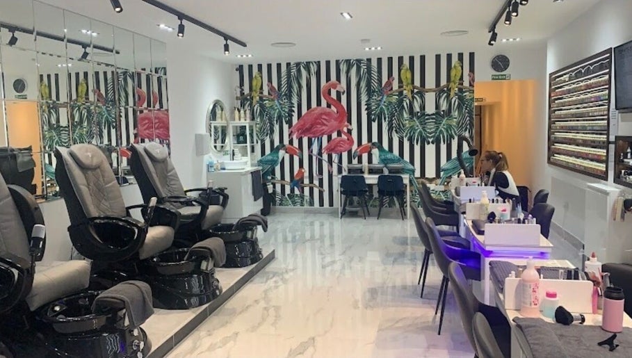 Ldn Lashes salon in Dartford, England featuring vibrant flamingo decor and modern spa chairs.