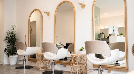 Chic salon interior at FMN Studio, Mungret Village, County Limerick, IE with modern chairs and elegant mirrors.
