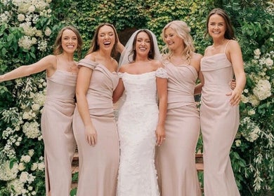 Smiling bridesmaids with bride at FMN Studio, Mungret Village, County Limerick, IE amidst lush green backdrop.