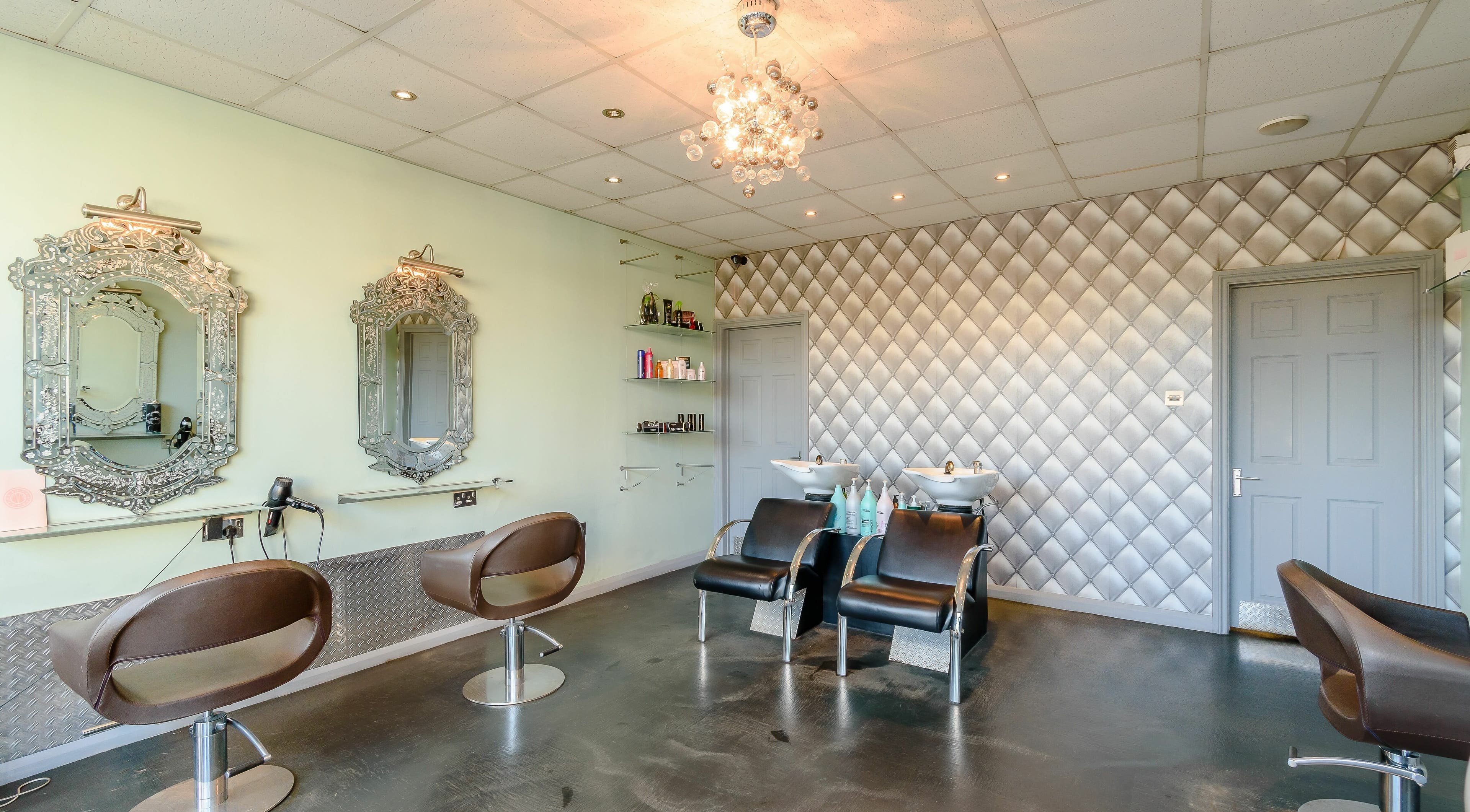 Elegantly designed interior of Emmy's at Salon 382, London, England, GB with stylish chairs and mirrors.