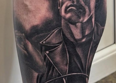 Detailed tattoo artwork on leg at Loved by few, Carlisle, England, GB, showcasing unique artistry and design.