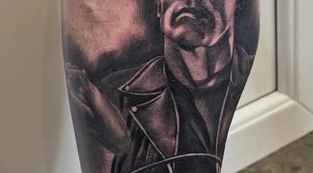 Detailed tattoo artwork on leg at Loved by few, Carlisle, England, GB, showcasing unique artistry and design.