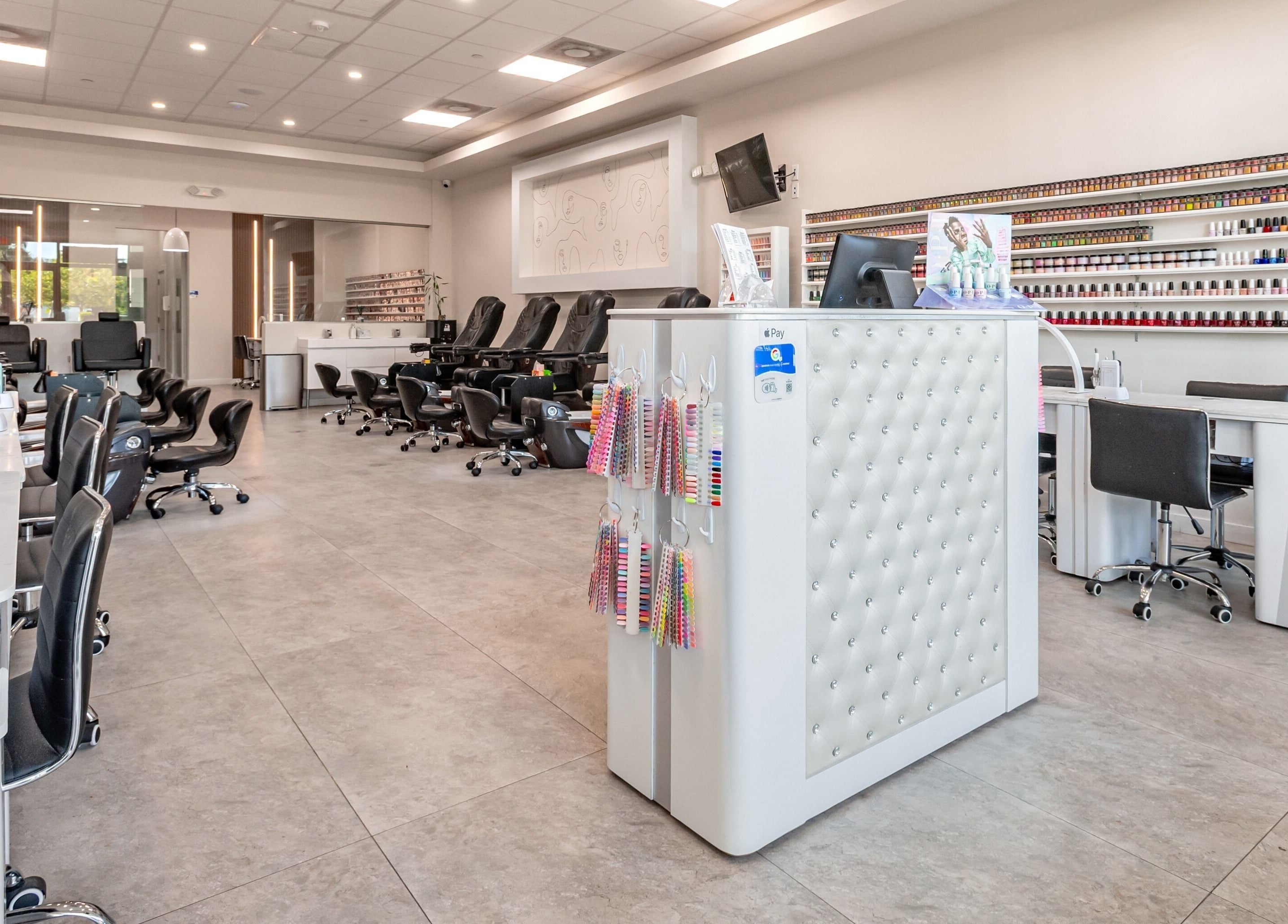 Spacious interior of Lash and Nail Spa in Miramar, Florida, US with manicure stations and neatly organized nail polishes.