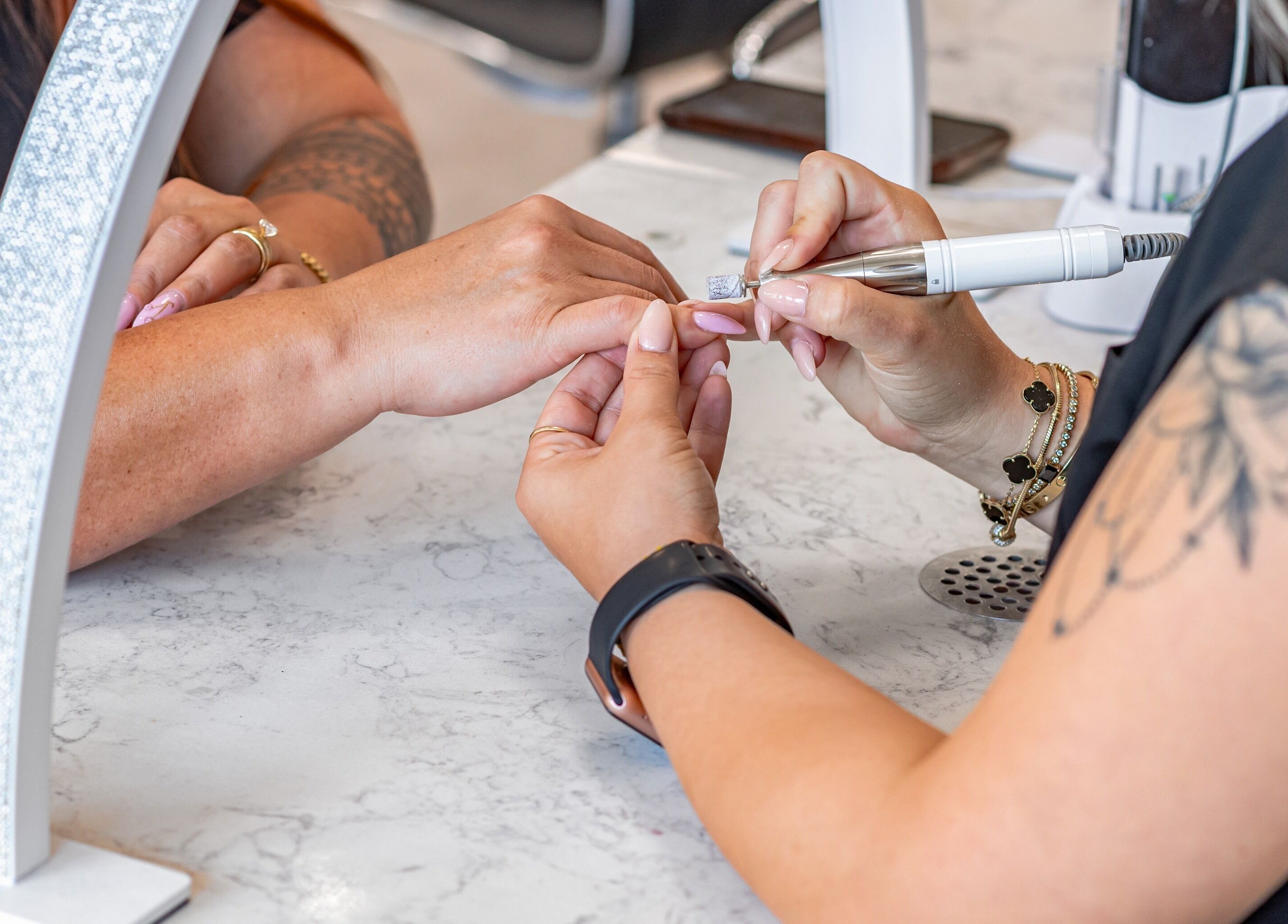 Nail technician perfecting manicure at Lash and Nail Spa, Miramar, Florida, US.