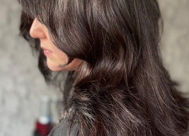 Elegant hairstyle at Roxanne Hair, Seafield Salon, Inverness, Scotland, GB showcasing glossy brown locks.