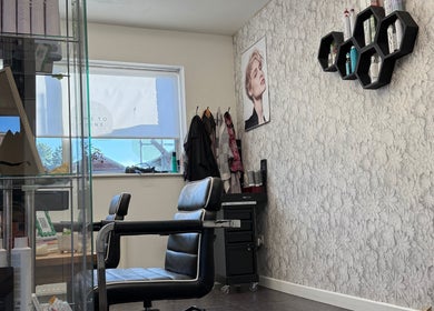 Chic interior of Roxanne Hair at Seafield Salon, Inverness, Scotland, GB with elegant seating and decor.