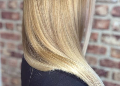 Sleek, shiny blonde hair styled at Travis Manning Hair Consultant, Great Yarmouth, England, GB.