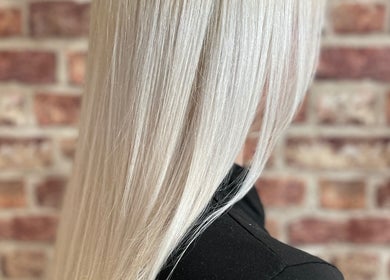 Sleek platinum blonde hair at Travis Manning Hair Consultant, Great Yarmouth, England, GB.