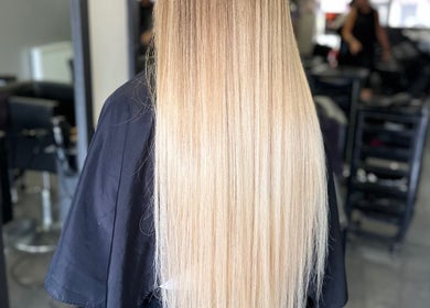 Long blonde hair styled at Travis Manning Hair Consultant, Great Yarmouth, England, GB.