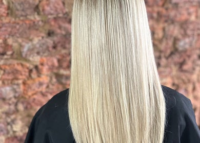 Smooth, shiny blonde hair at Travis Manning Hair Consultant in Great Yarmouth, England, GB.